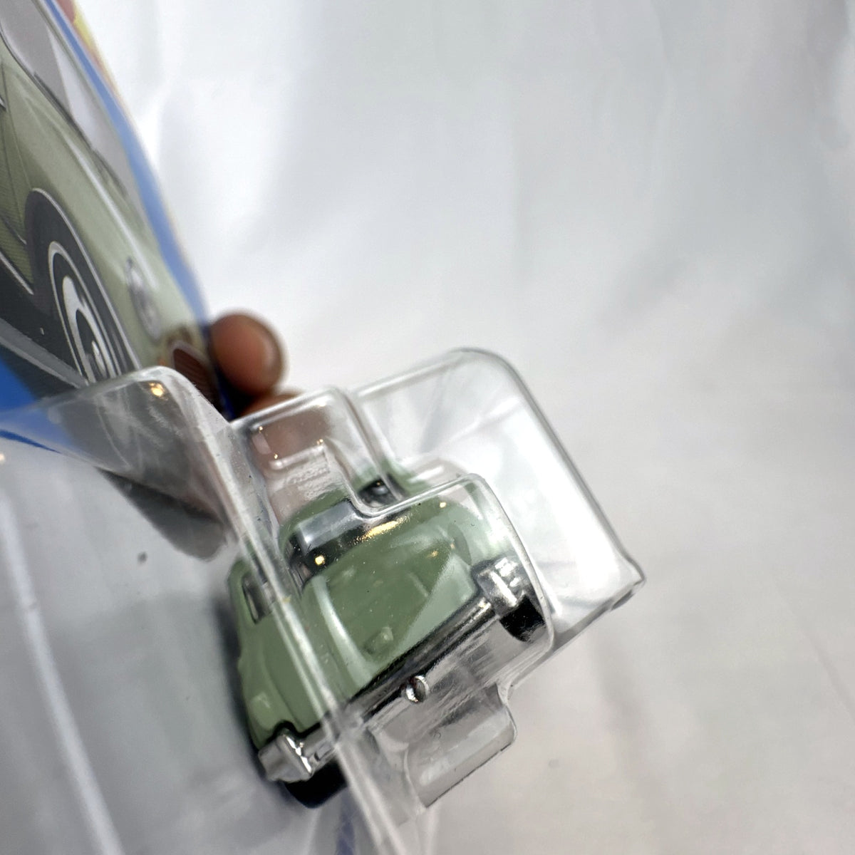 Hot Wheels 1965 Austin Mini Cooper S diecast car in sage green with white stripes, factory sealed in original packaging