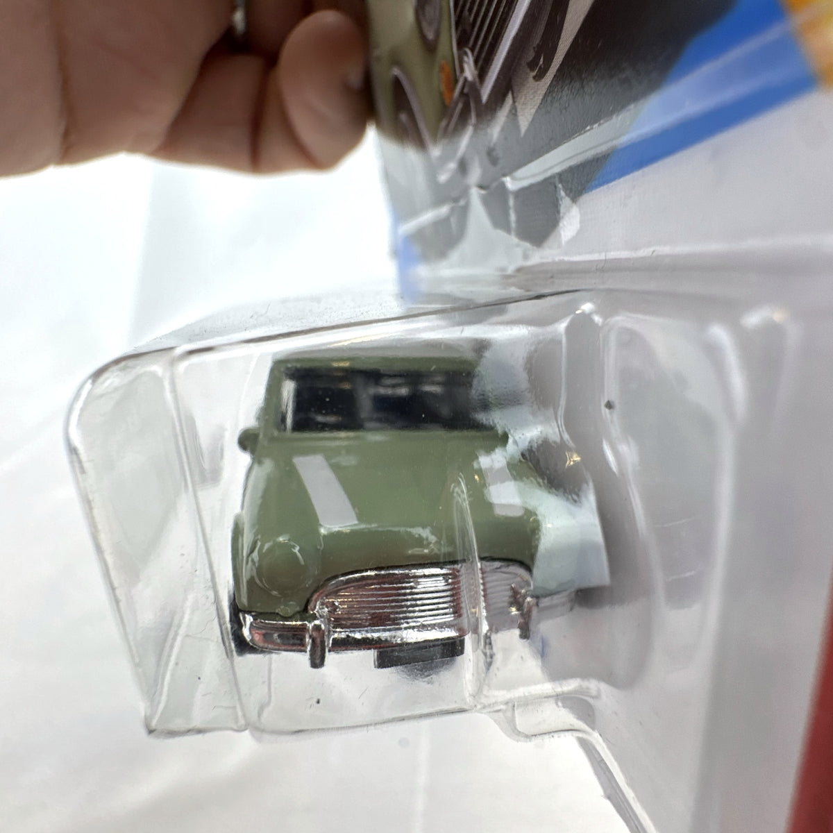 Hot Wheels 1965 Austin Mini Cooper S diecast car in sage green with white stripes, factory sealed in original packaging