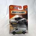 Matchbox 2023 Ford E-Transit Custom diecast van in gray with MBX Edition livery, sealed on card.