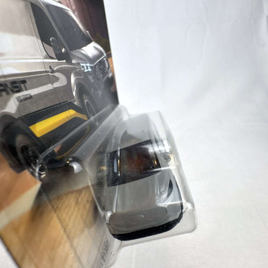 Matchbox 2023 Ford E-Transit Custom diecast van in gray with MBX Edition livery, sealed on card.