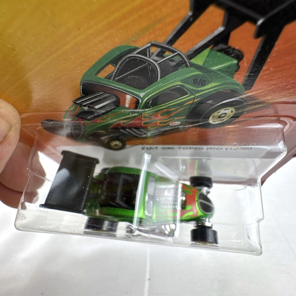 Hot Wheels 1936 Fiat 500 Topolino dragster in metallic green with red flames sealed on card.