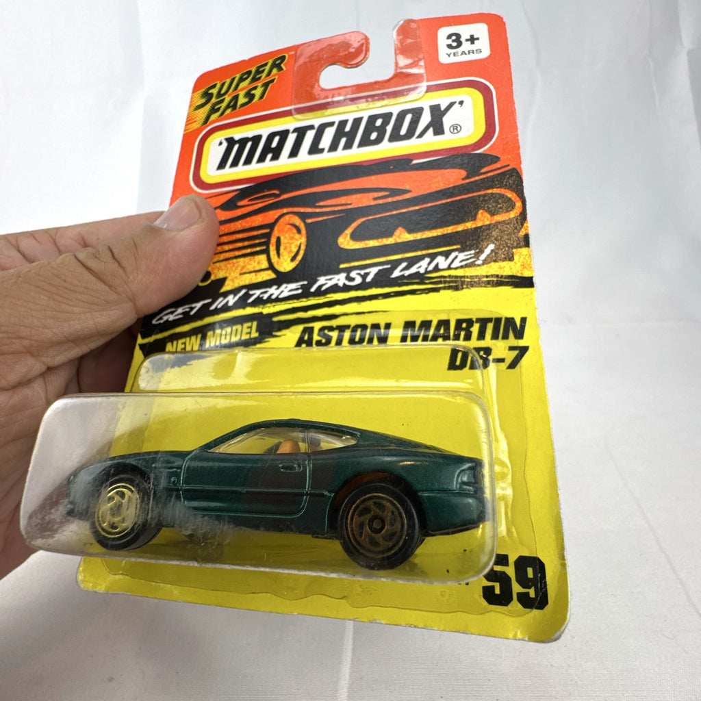 Sealed 1993 Matchbox Super Fast Aston Martin DB-7 diecast car #59 in deep metallic green with original card packaging.