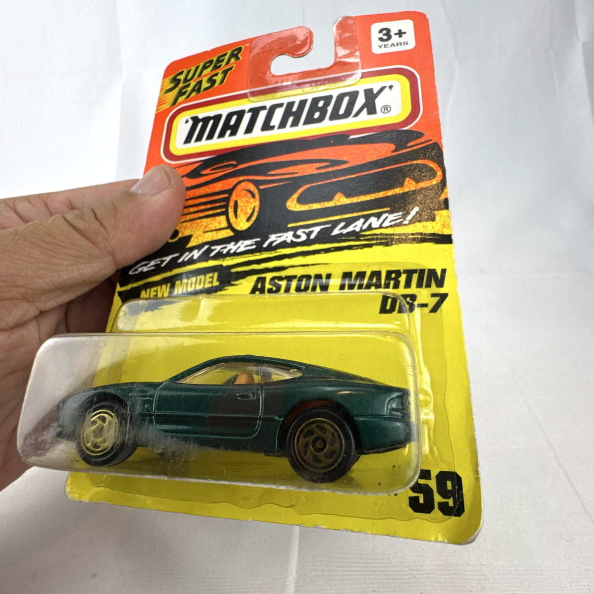 Sealed 1993 Matchbox Super Fast Aston Martin DB-7 diecast car #59 in deep metallic green with original card packaging.