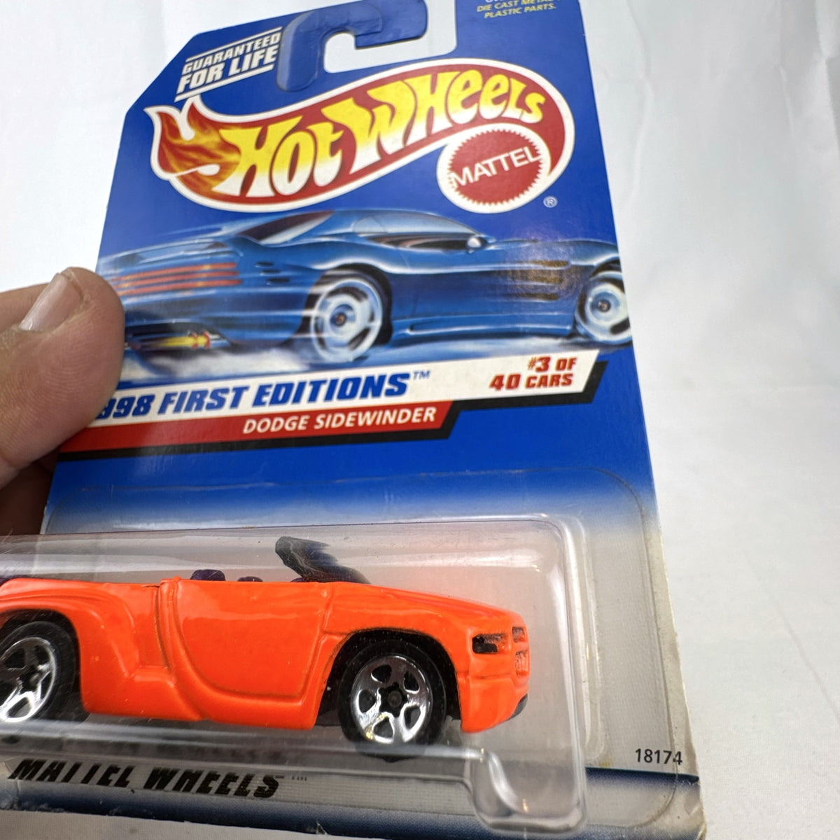 Factory sealed 1998 Hot Wheels First Editions Dodge Sidewinder diecast truck in neon orange on original card.