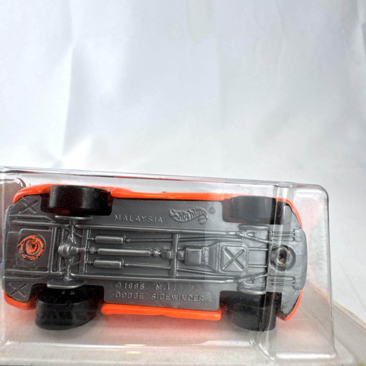 Factory sealed 1998 Hot Wheels First Editions Dodge Sidewinder diecast truck in neon orange on original card.