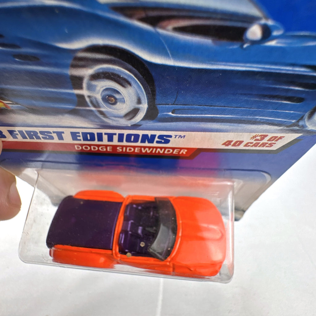 Factory sealed 1998 Hot Wheels First Editions Dodge Sidewinder diecast truck in neon orange on original card.