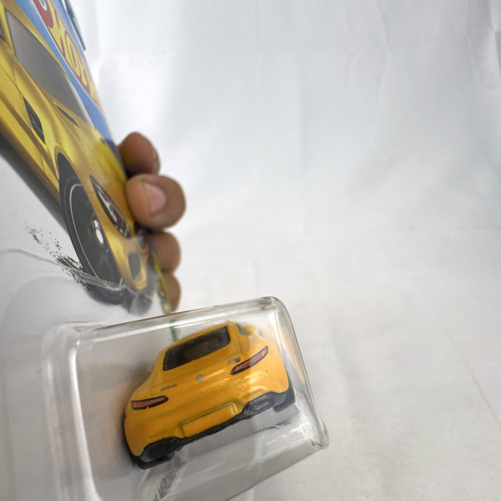 Sealed Hot Wheels 2017 HW Exotics 15 Mercedes-AMG GT diecast car in metallic yellow on original card