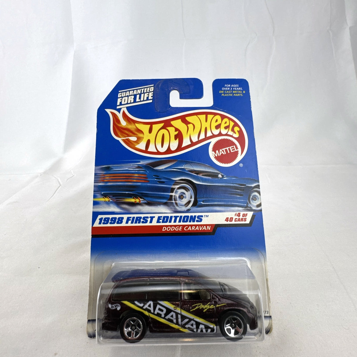 Sealed 1998 Hot Wheels First Editions Dodge Caravan diecast minivan in metallic purple on original card packaging.