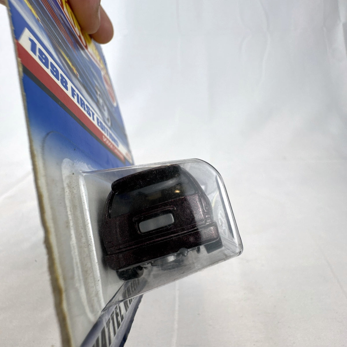 Sealed 1998 Hot Wheels First Editions Dodge Caravan diecast minivan in metallic purple on original card packaging.