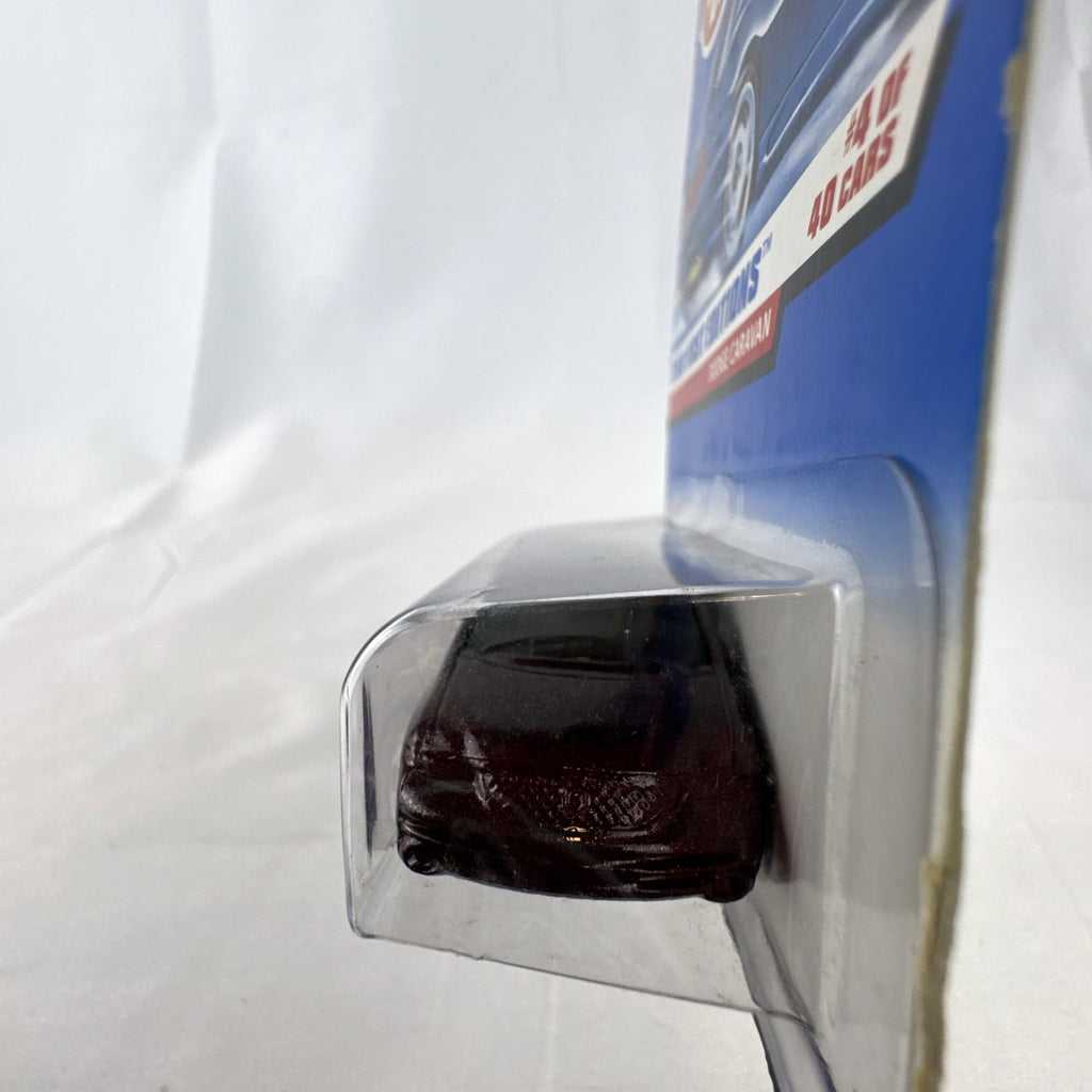 Sealed 1998 Hot Wheels First Editions Dodge Caravan diecast minivan in metallic purple on original card packaging.