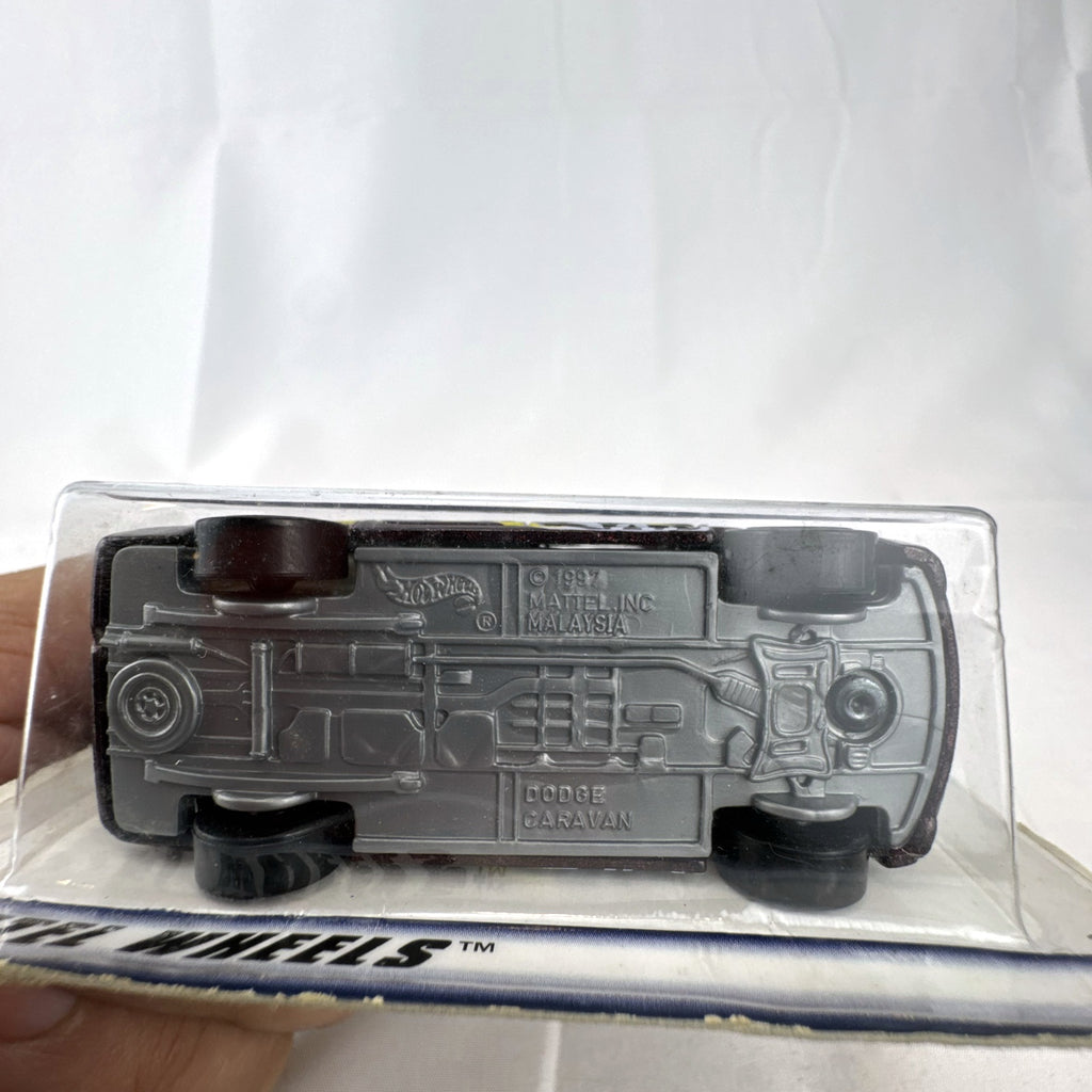 Sealed 1998 Hot Wheels First Editions Dodge Caravan diecast minivan in metallic purple on original card packaging.