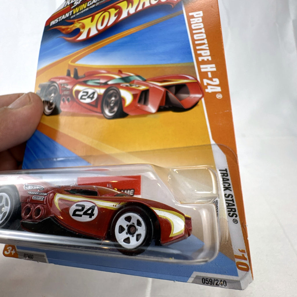 Sealed 2010 Hot Wheels Track Stars Prototype H-24 diecast car in dark metallic red on original blister card.