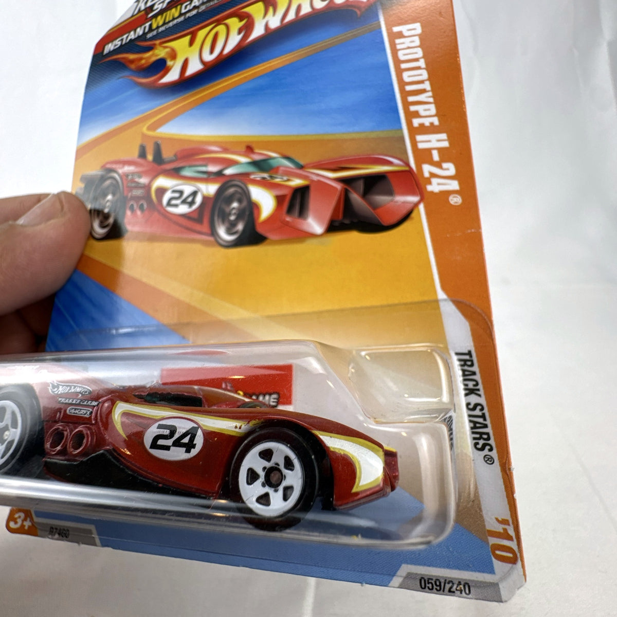 Sealed 2010 Hot Wheels Track Stars Prototype H-24 diecast car in dark metallic red on original blister card.