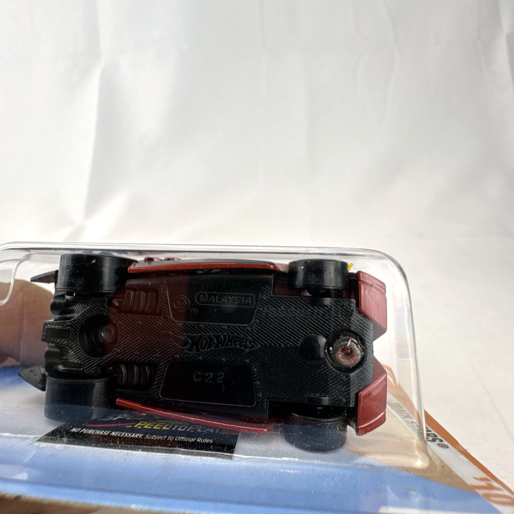Sealed 2010 Hot Wheels Track Stars Prototype H-24 diecast car in dark metallic red on original blister card.