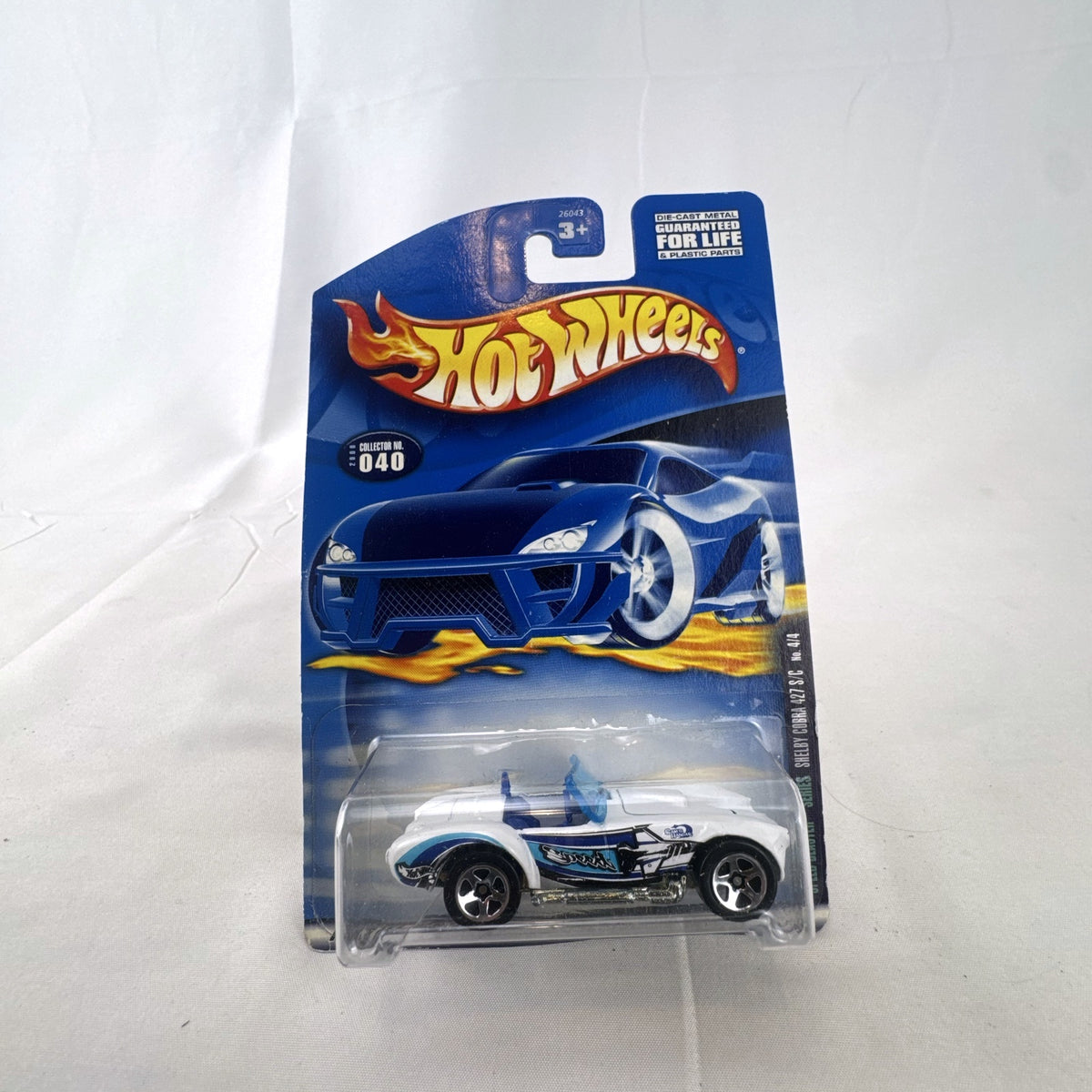 White Hot Wheels 2000 Speed Blaster Series Shelby Cobra 427 S/C diecast car sealed on its original card packaging.