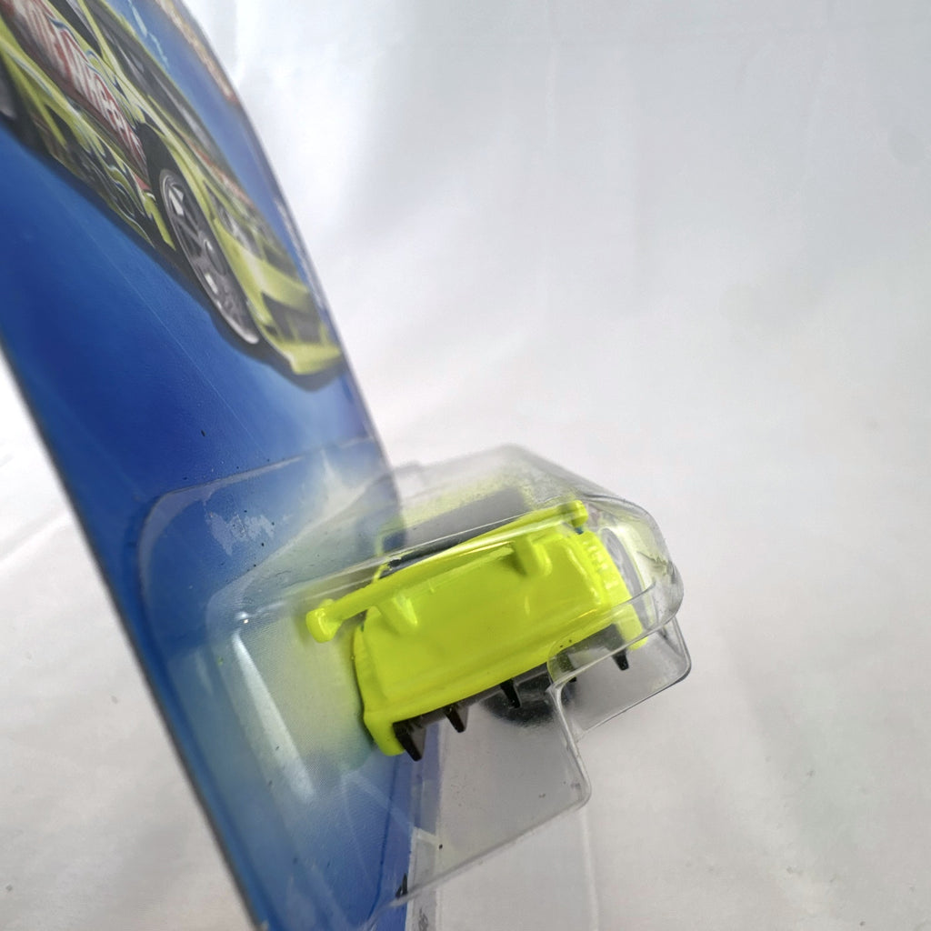 Hot Wheels Amazoom 1:64 scale diecast race car in chartreuse green with flame graphics on original blister card