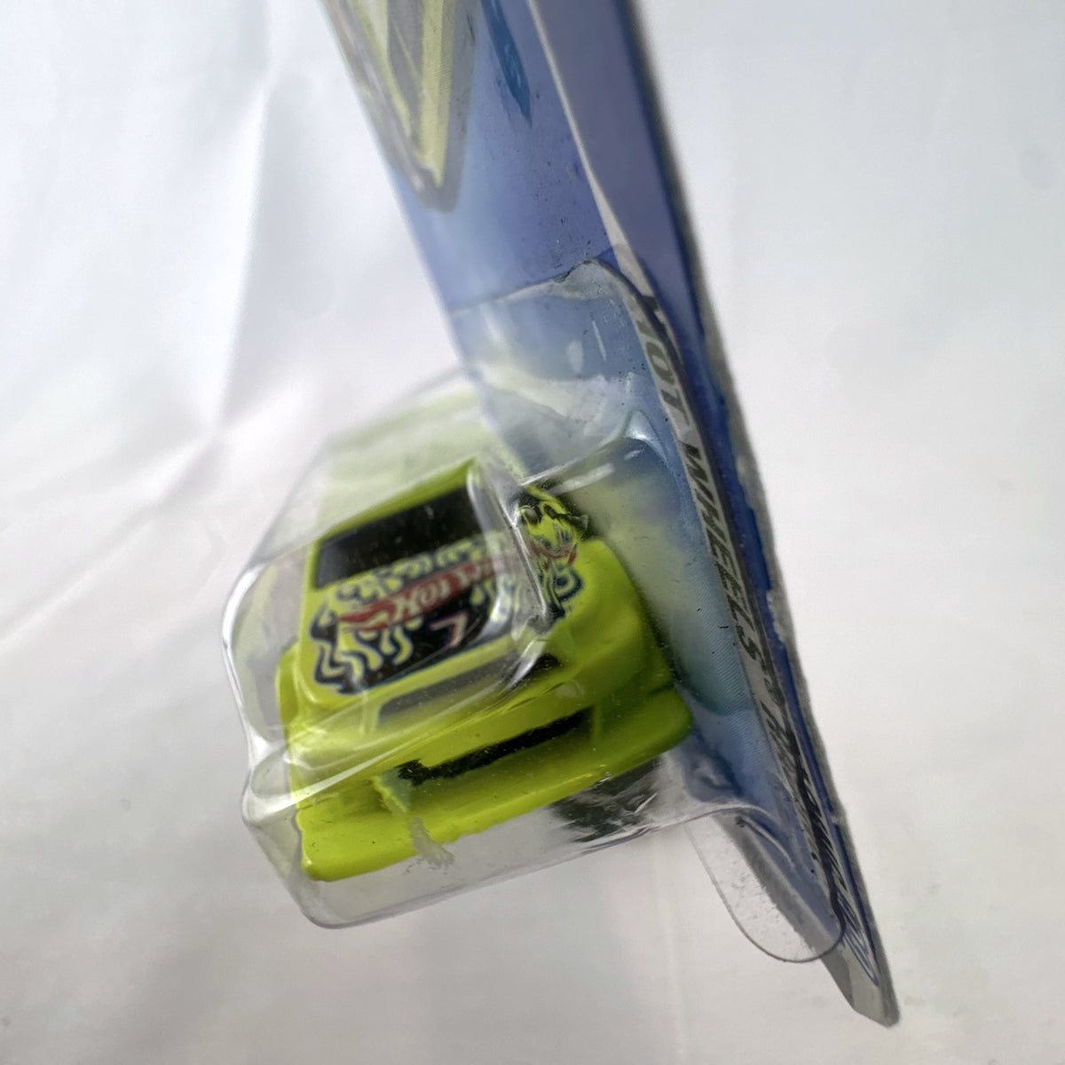 Hot Wheels Amazoom 1:64 scale diecast race car in chartreuse green with flame graphics on original blister card