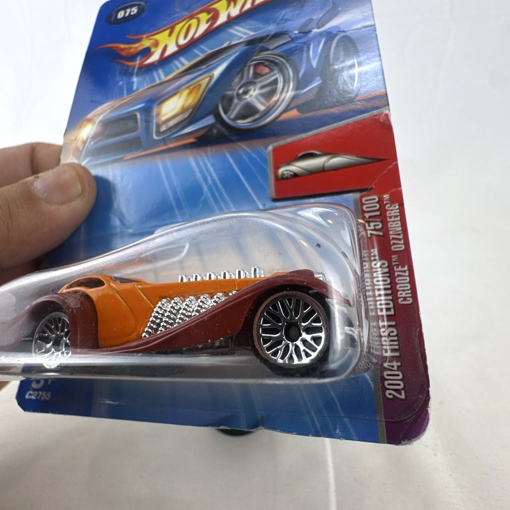 Sealed 2004 Hot Wheels First Editions Ozzenberg 1:64 diecast car in orange and maroon packaging.