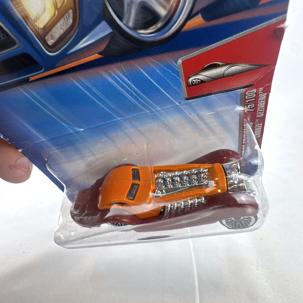 Sealed 2004 Hot Wheels First Editions Ozzenberg 1:64 diecast car in orange and maroon packaging.