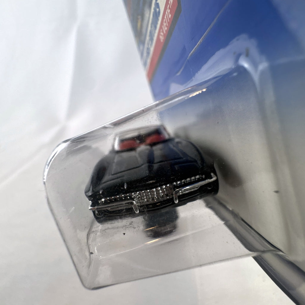 Hot Wheels 2000 First Editions 1965 Chevrolet Corvette diecast car in metallic black with red interior, unopened on card.