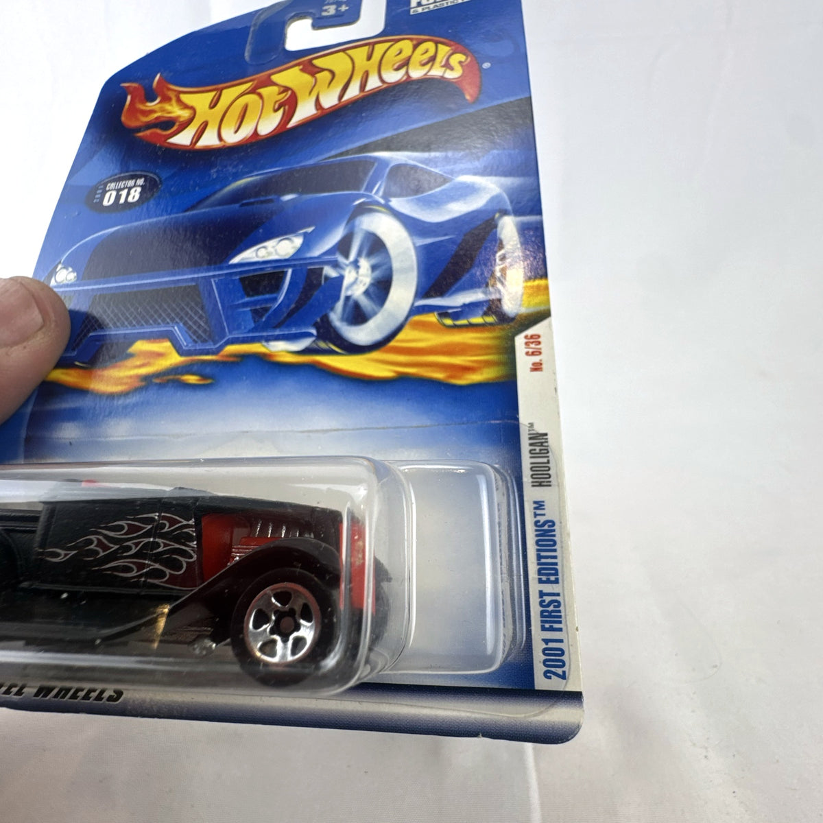 Sealed 2001 Hot Wheels First Editions Hooligan 1:64 diecast car in black with red flame graphics.