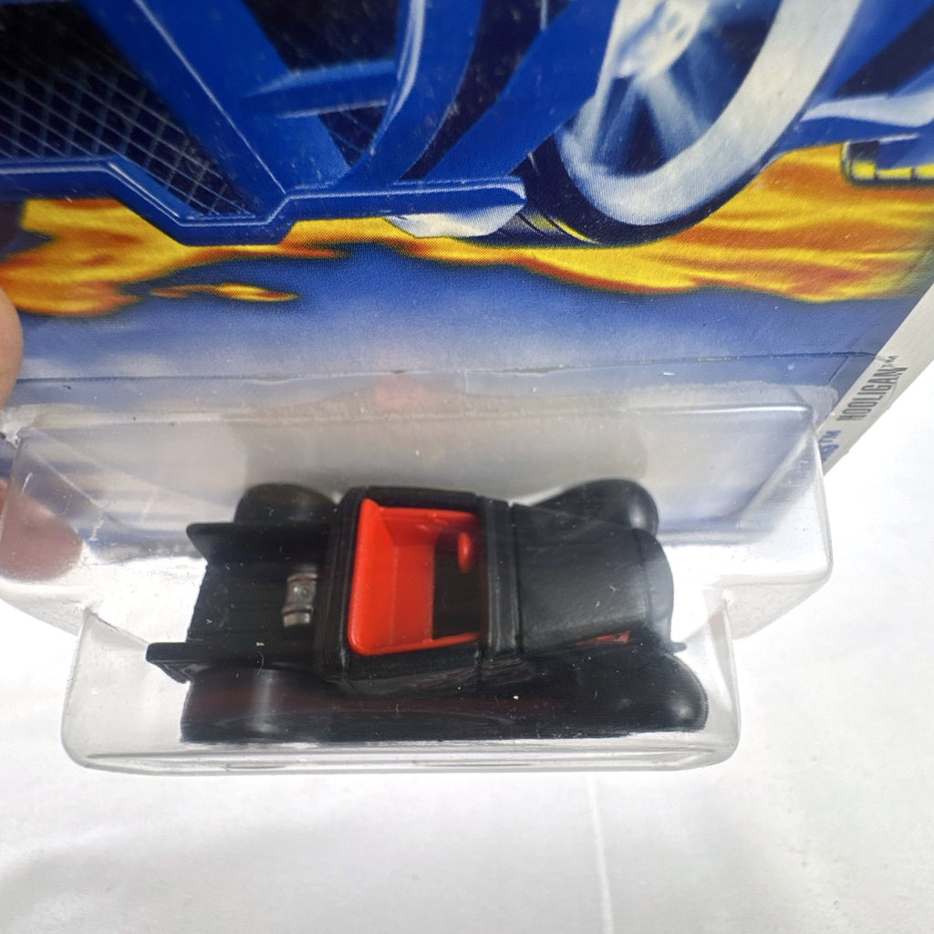 Sealed 2001 Hot Wheels First Editions Hooligan 1:64 diecast car in black with red flame graphics.