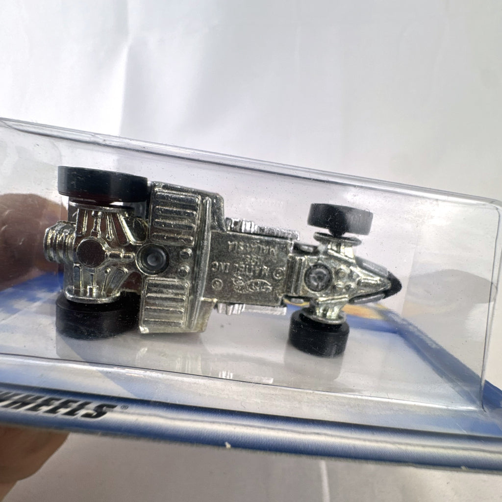 Hot Wheels 2001 Shadow Jet diecast car in chrome silver finish sealed in original card packaging.