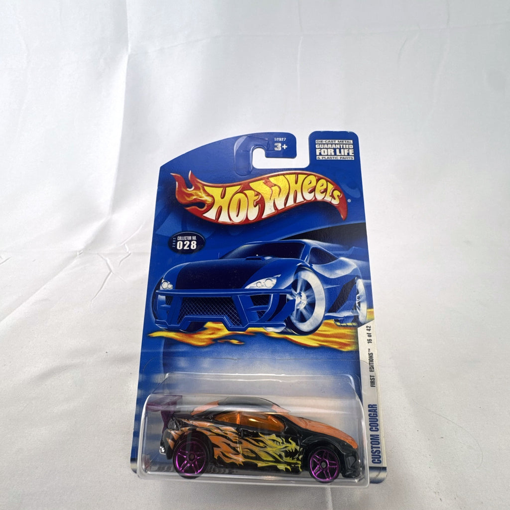 Hot Wheels 2002 First Editions Custom Cougar 1:64 diecast car in black with yellow and orange flames, factory sealed on card.