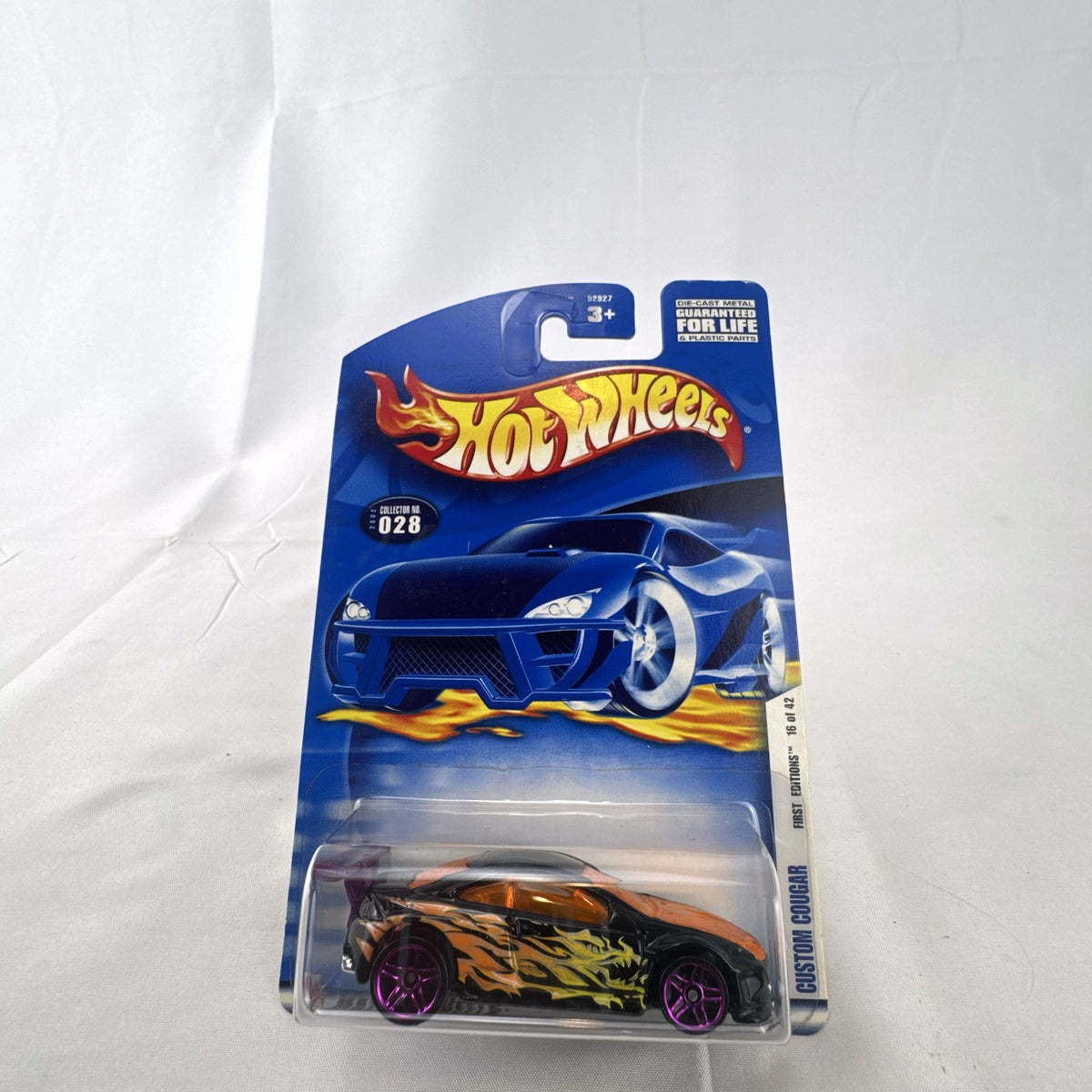 Hot Wheels 2002 First Editions Custom Cougar 1:64 diecast car in black with yellow and orange flames, factory sealed on card.
