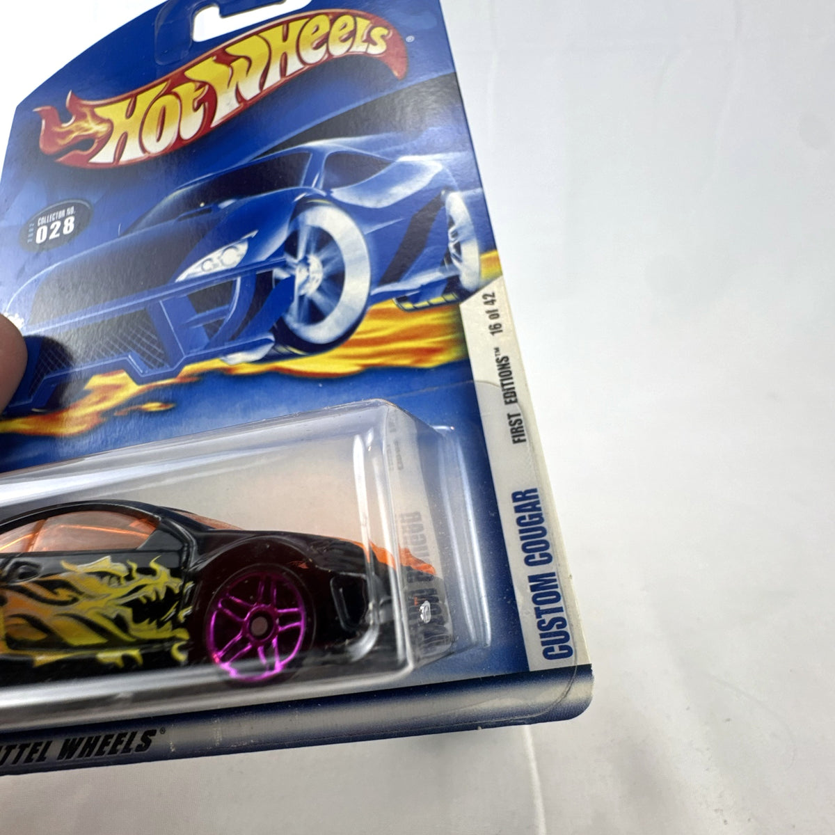 Hot Wheels 2002 First Editions Custom Cougar 1:64 diecast car in black with yellow and orange flames, factory sealed on card.