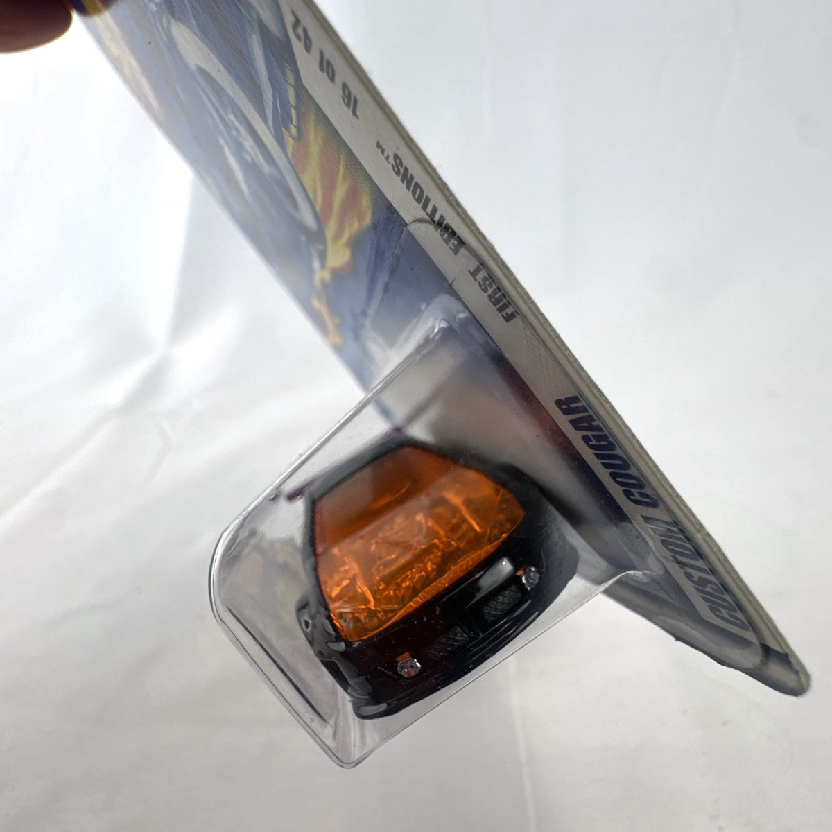 Hot Wheels 2002 First Editions Custom Cougar 1:64 diecast car in black with yellow and orange flames, factory sealed on card.