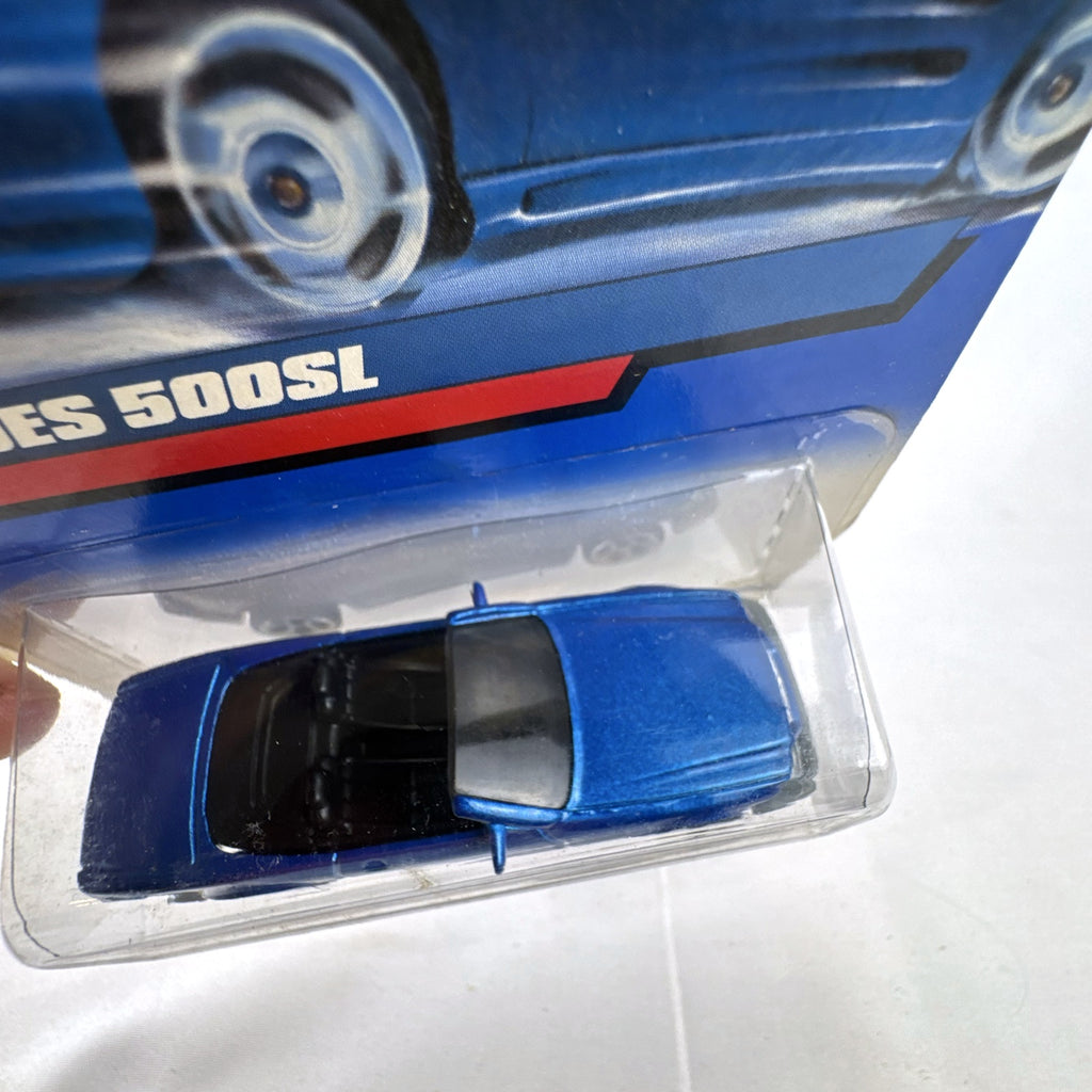 Hot Wheels 1:64 scale 1989 Mercedes-Benz 500SL convertible diecast car in metallic blue on original 2000 card.
