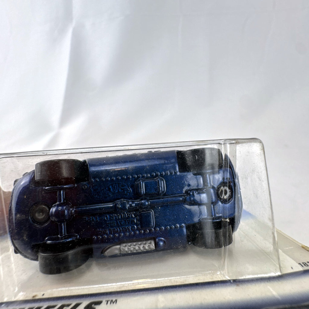 Hot Wheels 1998 First Editions Jaguar D-Type 1:64 diecast car in dark metallic blue factory sealed packaging