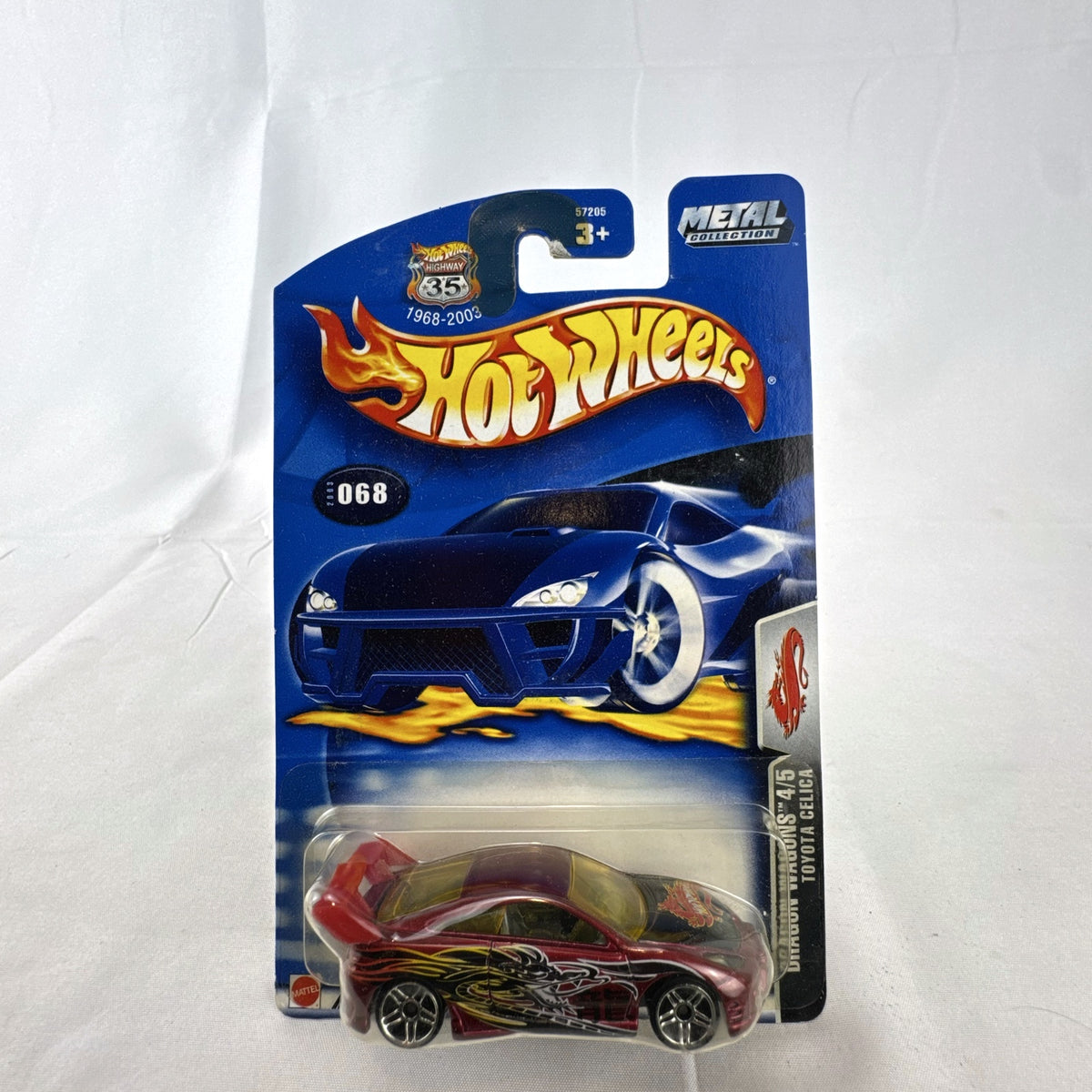 2003 Hot Wheels Toyota Celica Dragon Wagons diecast car in metallic red sealed on card