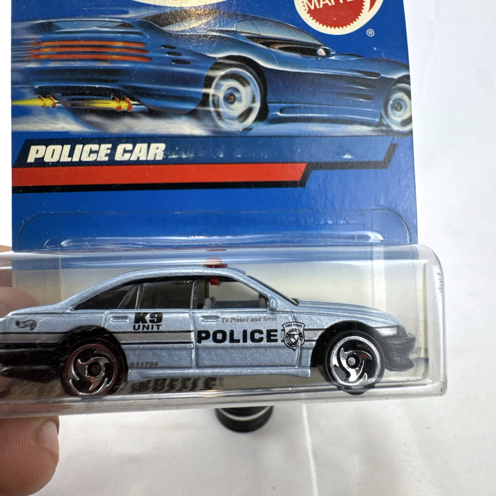 Hot Wheels 1:64 scale silver State Police K9 Unit cruiser diecast car sealed on original card packaging