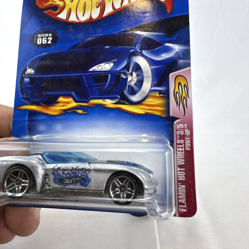 Hot Wheels 2003 Flamin' Hot Wheels Pony-Up 1:64 diecast car in silver with blue flames, factory sealed on blister card.
