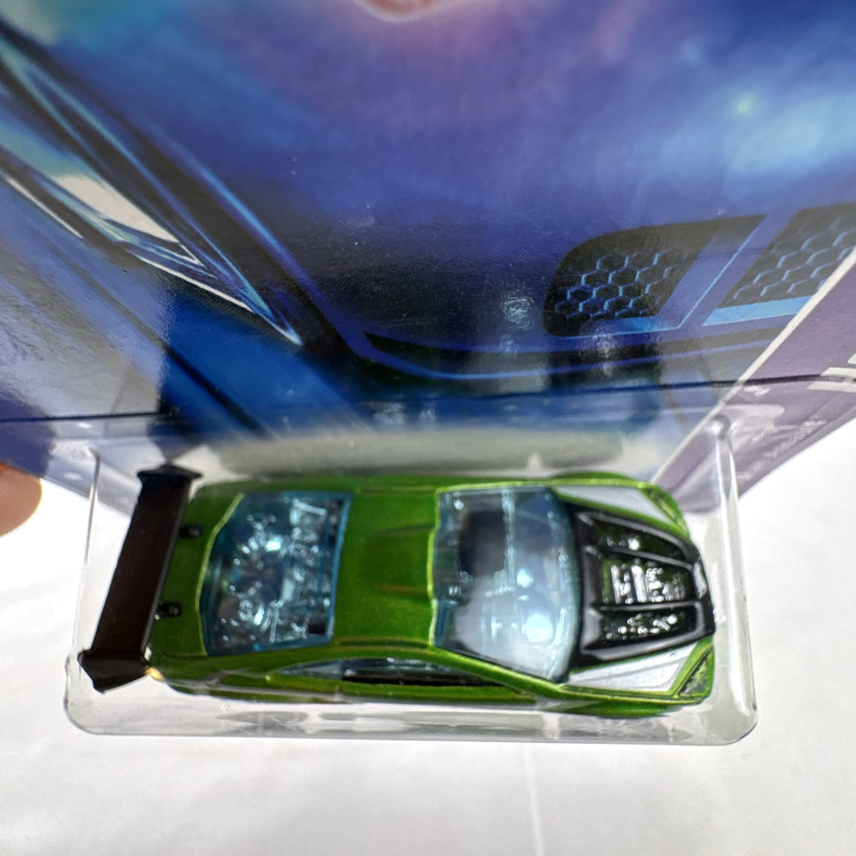 Hot Wheels Asphalt Assault 1:64 diecast car in metallic green sealed on original short card packaging.