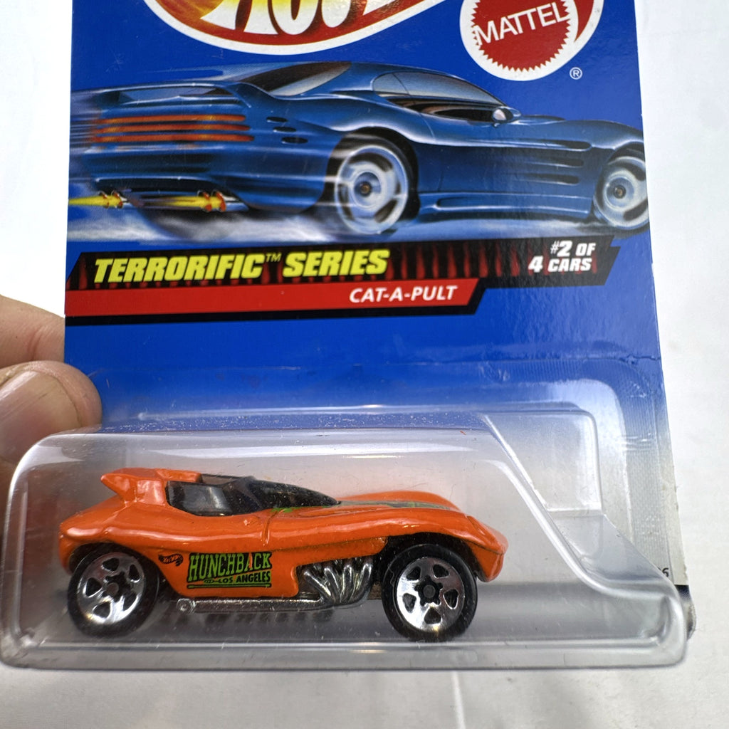 Factory sealed Hot Wheels Cat-A-Pult 1:64 scale diecast car in bright orange from the 1999 Terrorific Series.