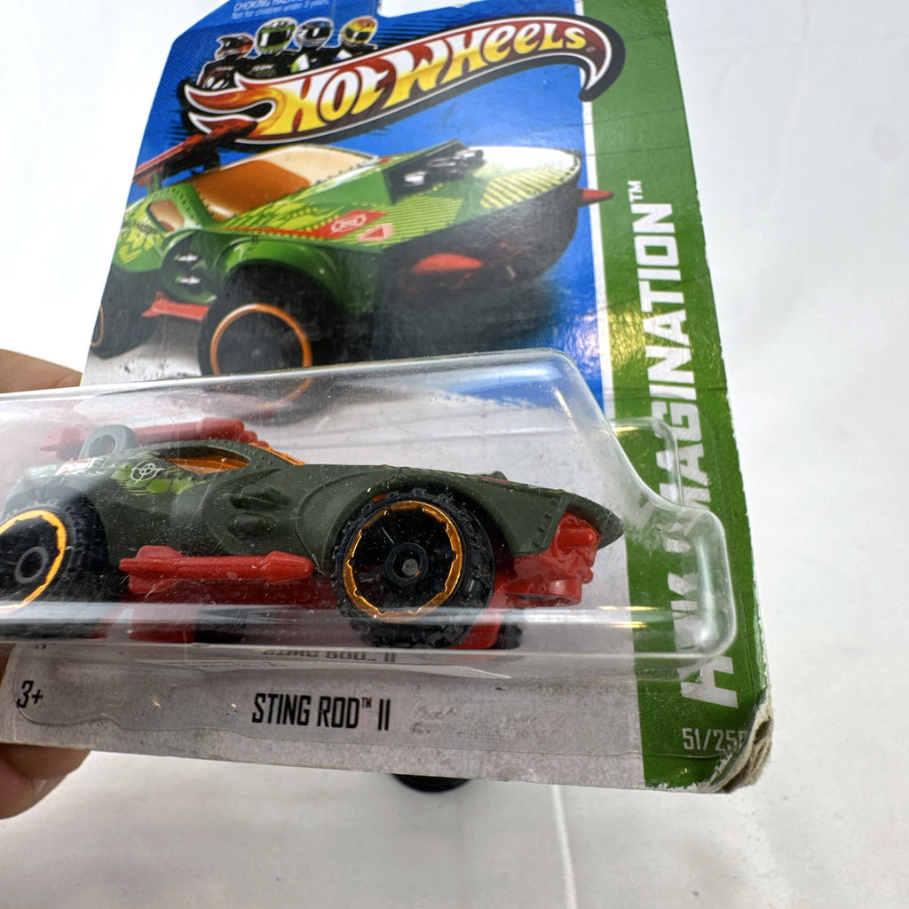 Factory sealed 1:64 scale Hot Wheels Sting Rod II diecast car in olive green on original card