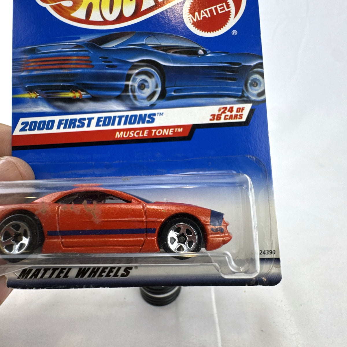 Hot Wheels Muscle Tone diecast car in metallic orange sealed on original 2000 First Editions card.