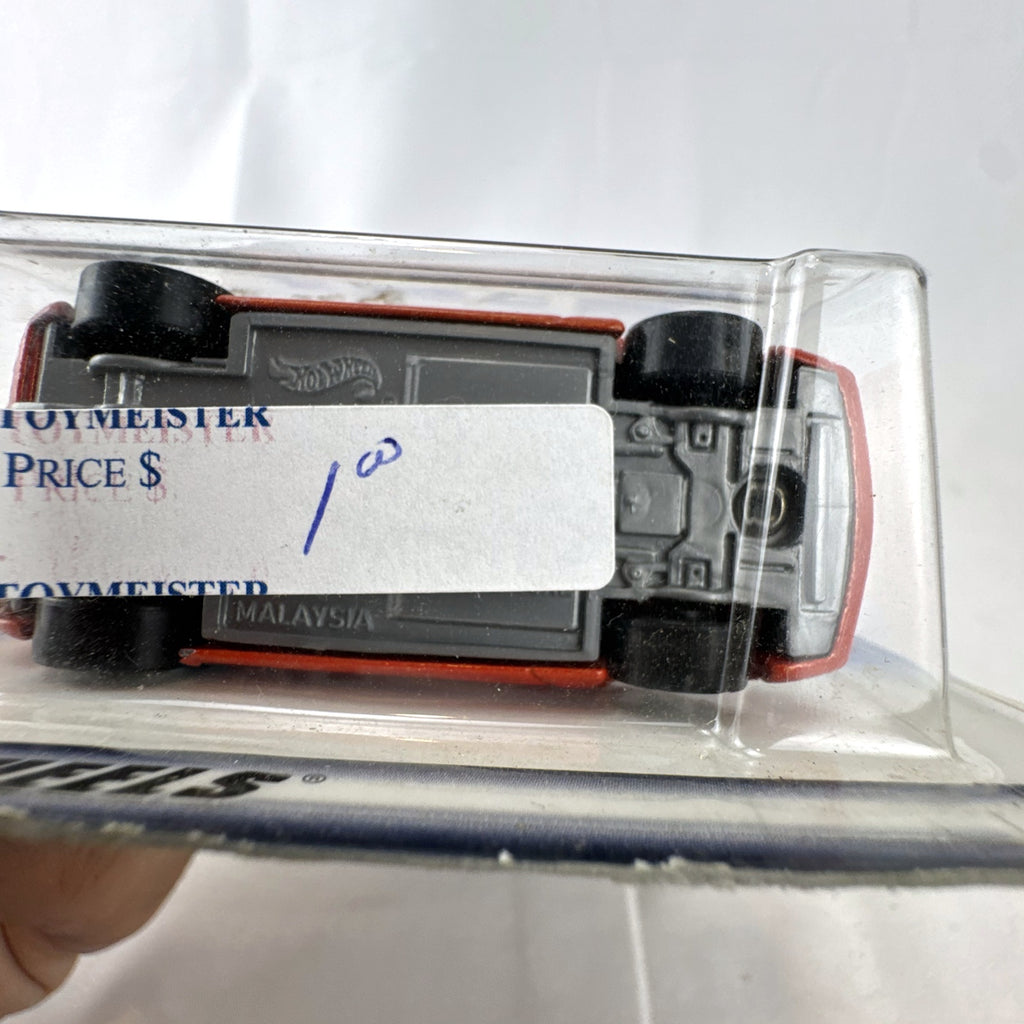 Hot Wheels Muscle Tone diecast car in metallic orange sealed on original 2000 First Editions card.