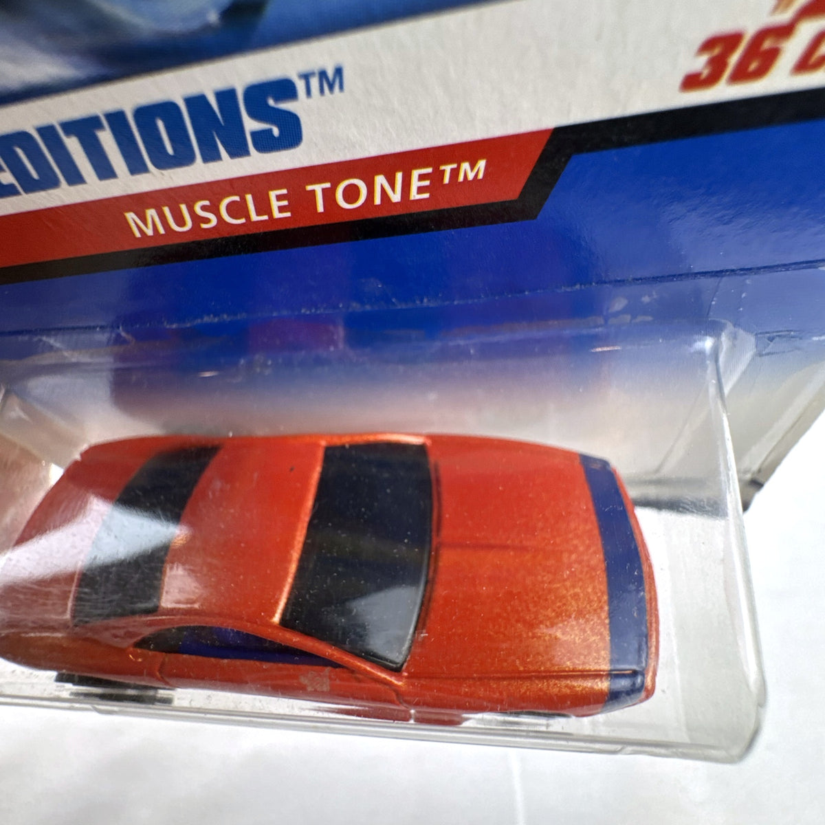 Hot Wheels 2000 First Editions Muscle Tone diecast car in metallic orange on original card
