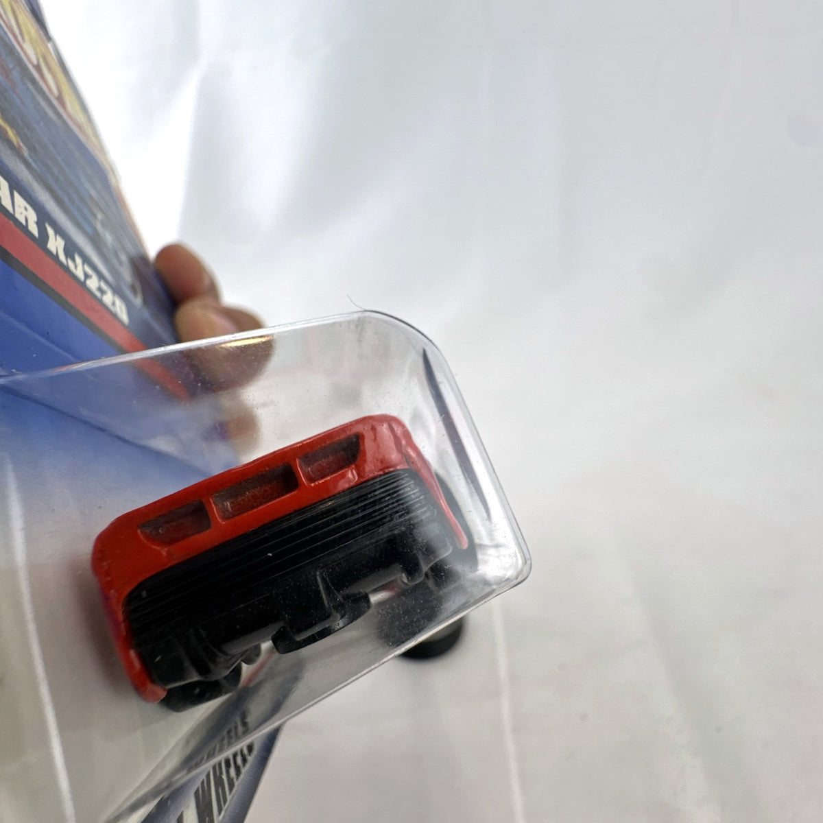 Hot Wheels 2000 Mainline 1:64 scale red Jaguar XJ220 diecast car in original blister packaging