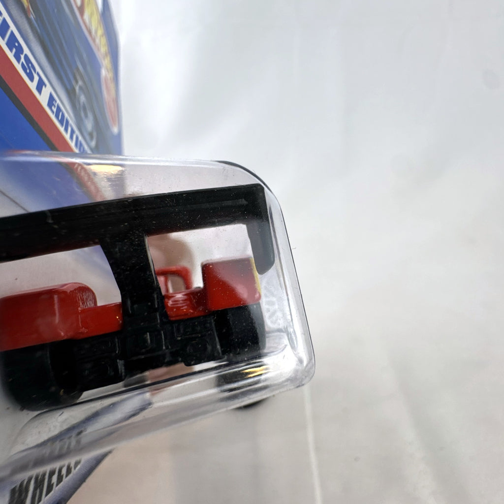 Hot Wheels 2000 First Editions Ferrari 333 SP 1:64 diecast race car in red with yellow flame graphics, sealed on card.