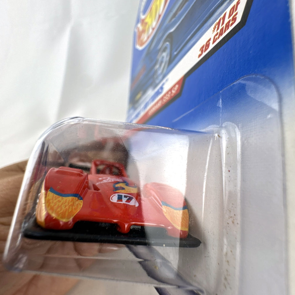 Hot Wheels 2000 First Editions Ferrari 333 SP 1:64 diecast race car in red with yellow flame graphics, sealed on card.