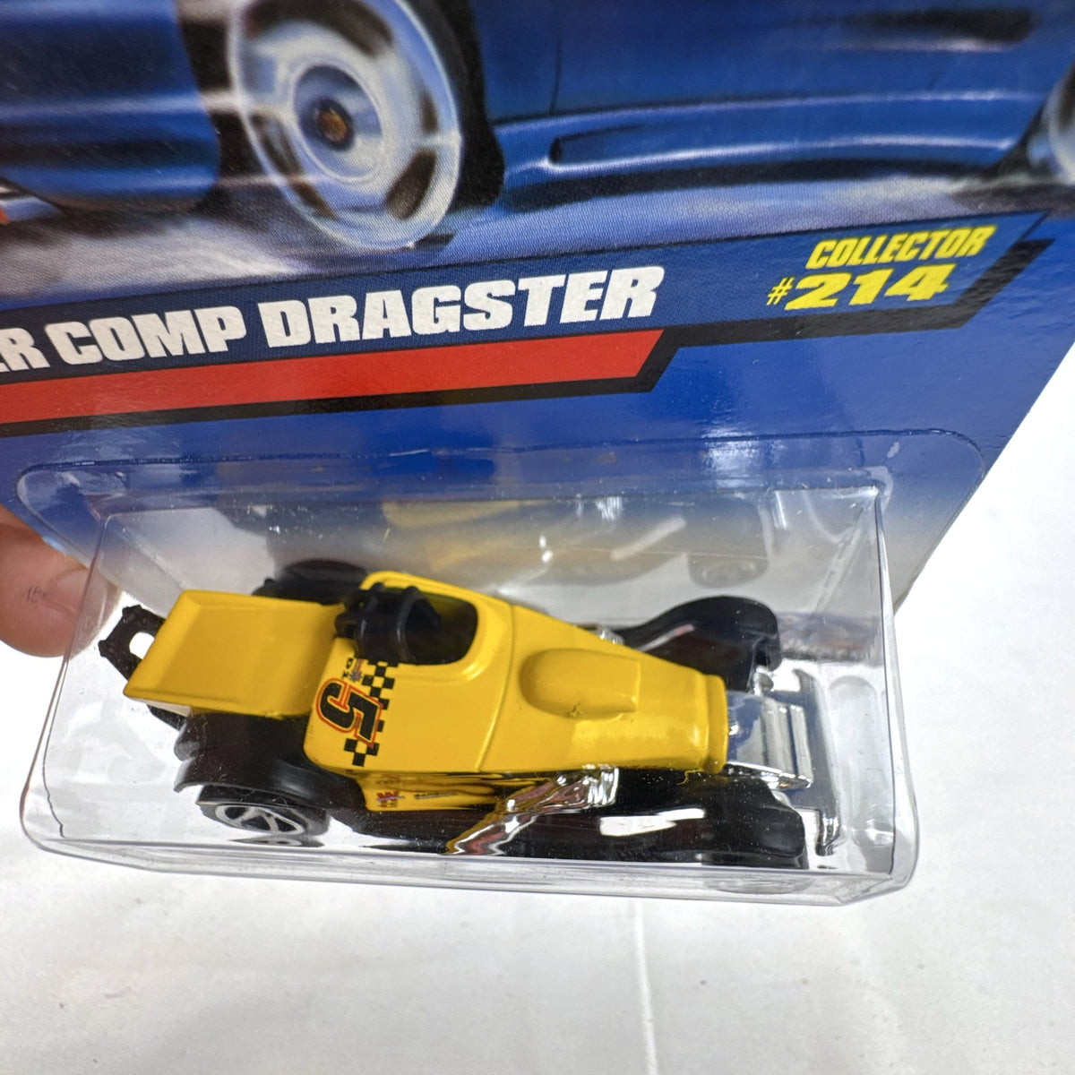 Hot Wheels 2000 Super Comp Dragster 1:64 scale diecast car in yellow with black flames sealed on card