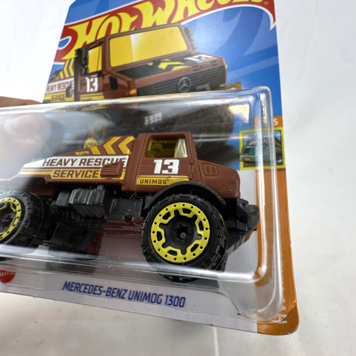 Hot Wheels 1:64 scale Mercedes-Benz Unimog 1300 diecast rescue truck in brown, sealed on card