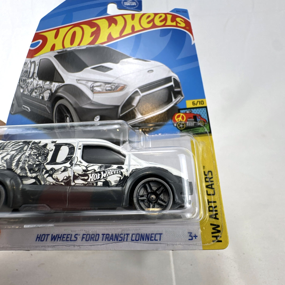 Hot Wheels Ford Transit Connect HW Art Cars 1:64 scale diecast van in white with tiger graphics