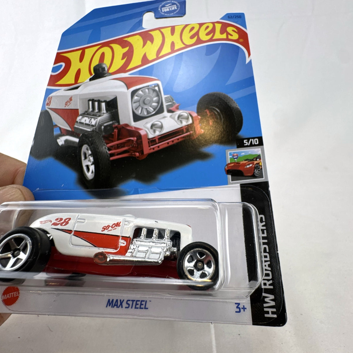 Unopened Hot Wheels Max Steel diecast car in white with red So-Cal Speed Shop graphics in 1:64 scale packaging.