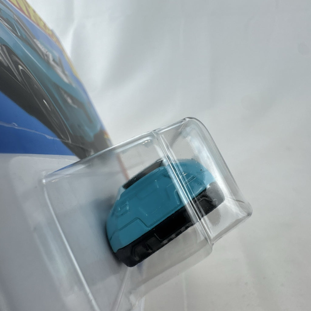 Hot Wheels Twinduction 1:64 scale diecast muscle car in light blue, factory sealed on original Muscle Mania card.